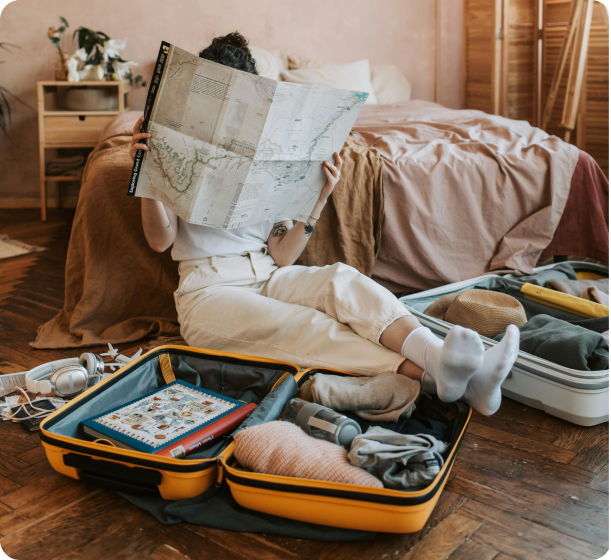 a person packing things and looking into a map